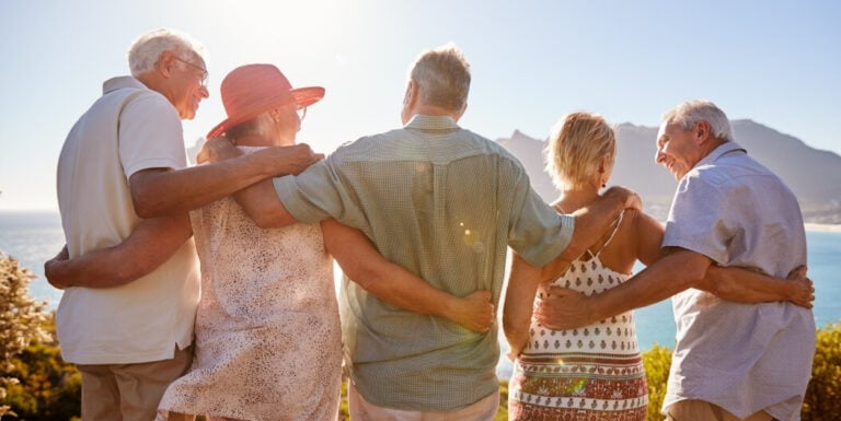 Group of Elderly Adults Standing Together Outdoors at a Memory Care Facility