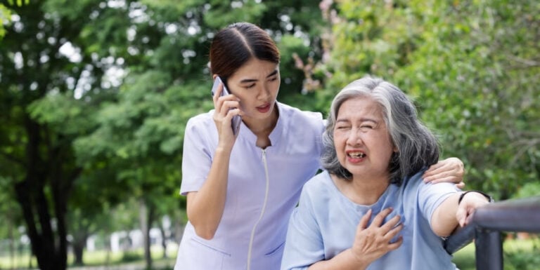 Female Nurse Calling for Help during Medical Emergency at Assisted Living Facility