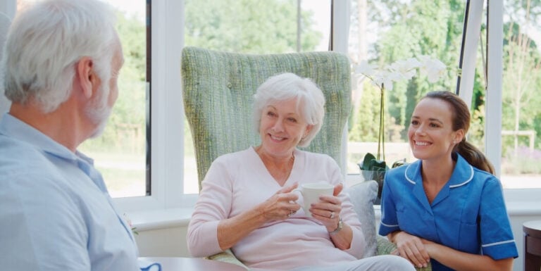 Nursing Staff Chatting with Resident and Family at Assisted Living Facility